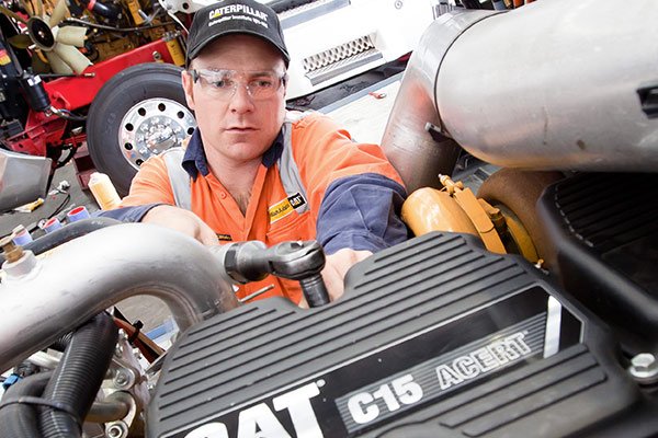 Cat mechanic working on an engine