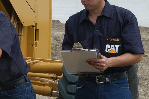 Cat employees doing an oil analysis