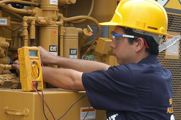 Cat employee checking oil