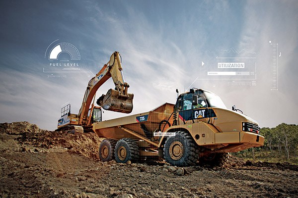Large Cat Hydraulic Excavator scooping dirt into an articulated truck